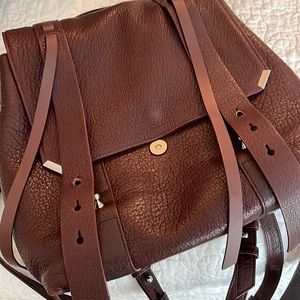 In Very good condition, dark brown leather backpack or crossbody purse